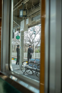 Security guards seen through window in city