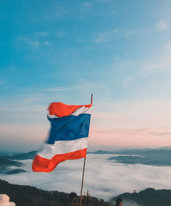 Low angle view of flag against sky during sunset