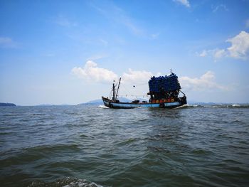 Boat sailing in sea against sky