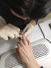 High angle view of woman hand