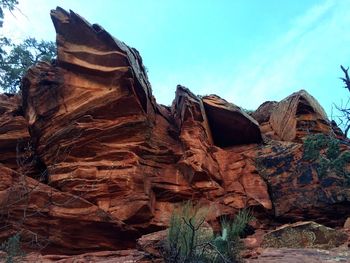 Low angle view of rock formation against sky