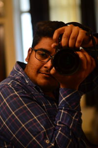 Close-up of man holding eyeglasses