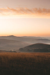 Scenic view of field against sky during sunset