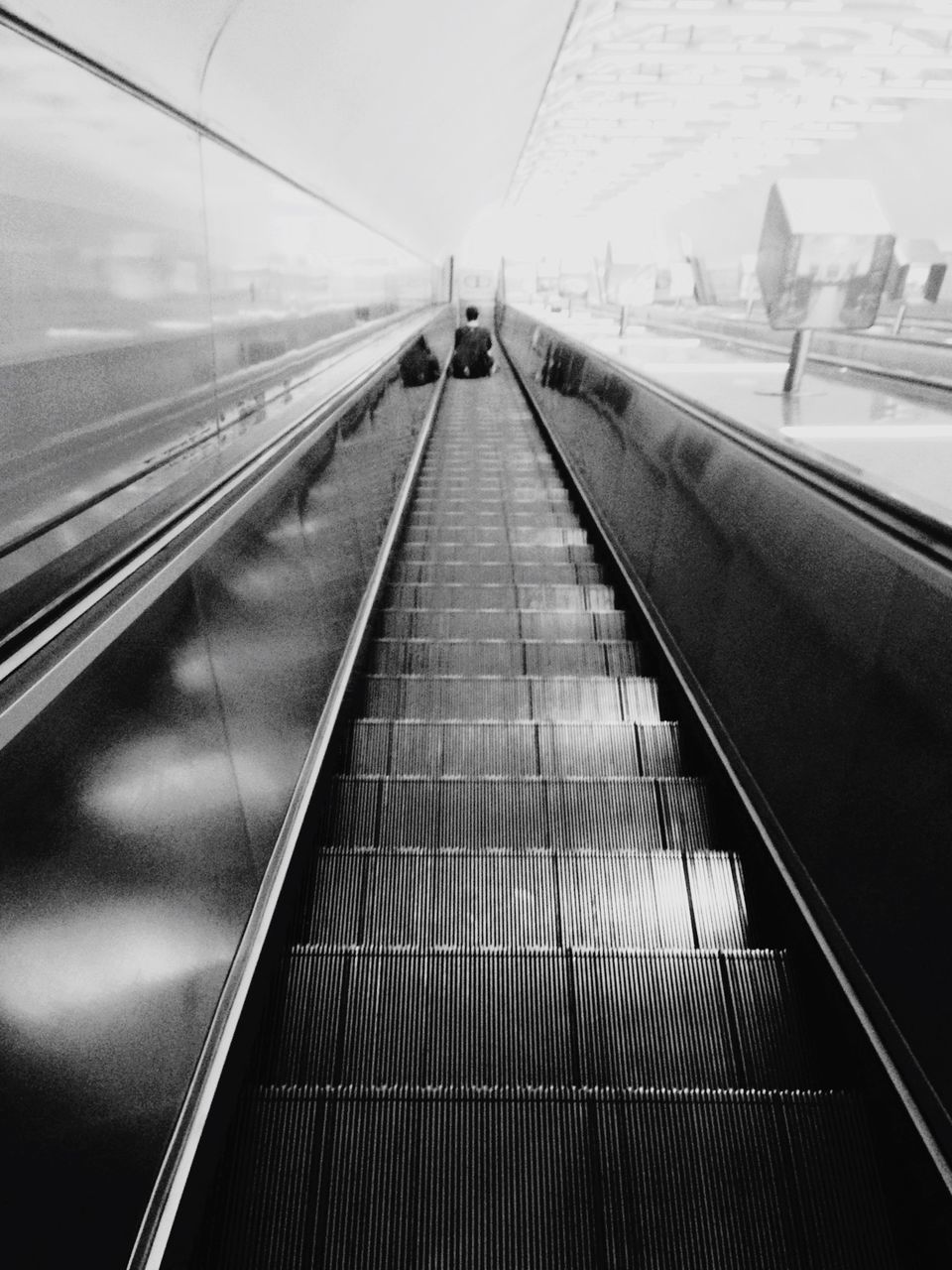 transportation, railroad track, rail transportation, public transportation, railroad station platform, mode of transport, railroad station, indoors, travel, train - vehicle, diminishing perspective, on the move, high angle view, the way forward, escalator, journey, vanishing point, railing, railway track, day