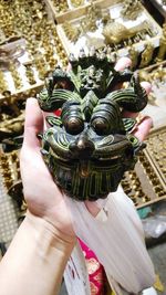 Close-up of hand holding sculpture
