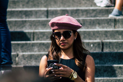 Young woman using mobile phone outdoors