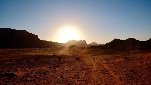 Scenic view of desert against sky during sunset