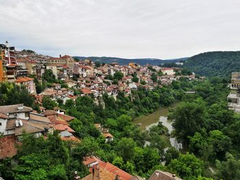 High angle view of houses in town against sky