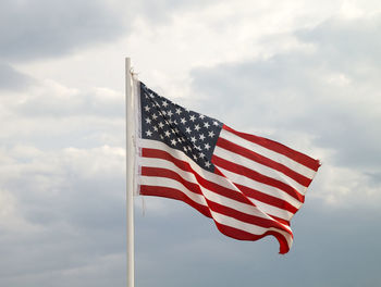 Low angle view of flags flag against sky