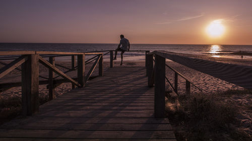 Scenic view of pier on sea against sky during sunset