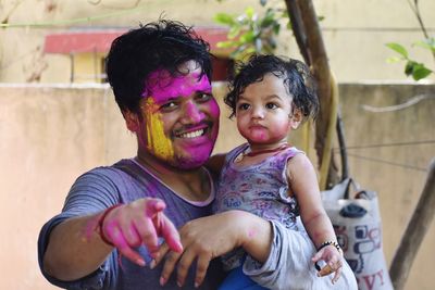 Festival time, holi, father and cute daughter