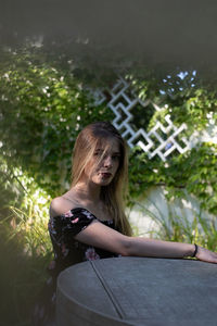 Portrait of woman against tree