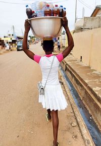 Rear view of woman standing in front of building