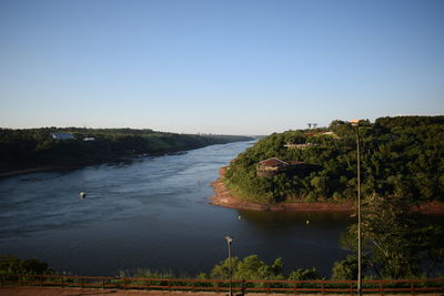 Scenic view of lake against clear blue sky