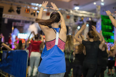 Rear view of woman dancing at nightclub