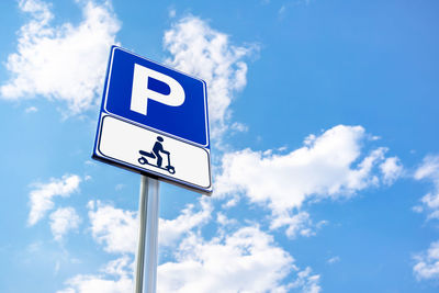 Low angle view of road sign against sky