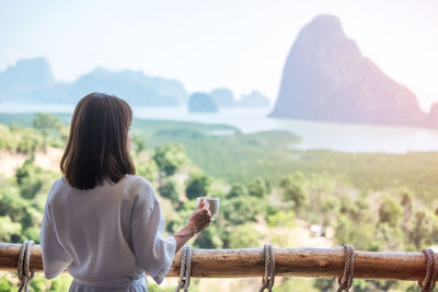 Rear view of woman looking at mountains