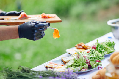 Midsection of person holding food in plate