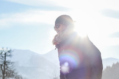 Man standing on mountain against sky