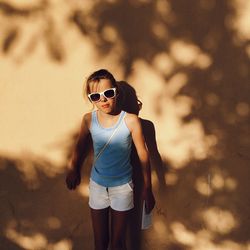 Full length of girl wearing sunglasses standing outdoors