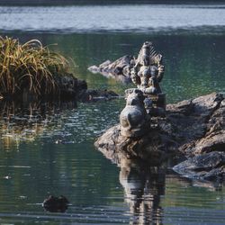 View of sculpture in lake