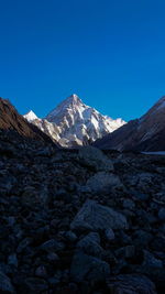 Scenic view of snowcapped mountains against clear blue sky