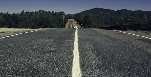 Road by mountain against clear sky