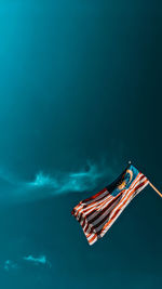 Low angle view of flag against blue sky