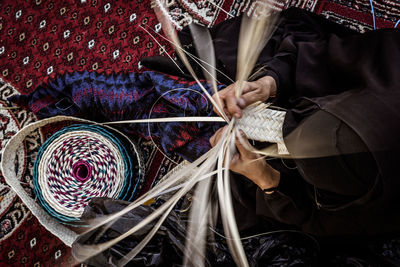 High angle view of woman weaving