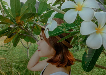 Portrait of woman with plants in park