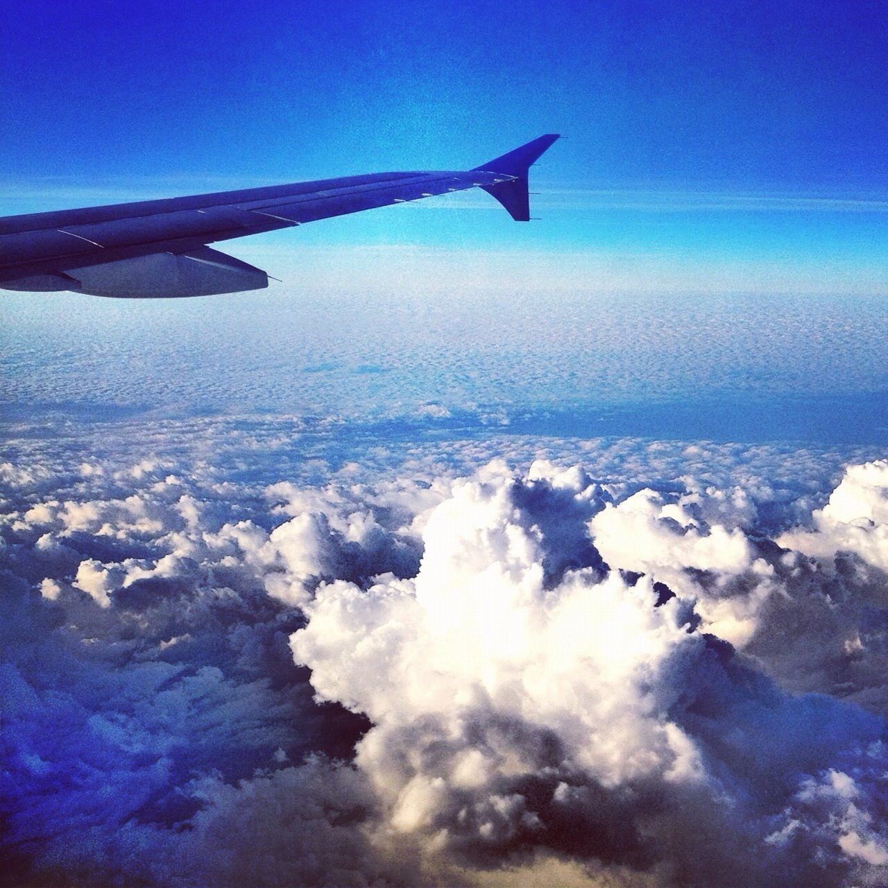 airplane, flying, aircraft wing, air vehicle, transportation, mode of transport, part of, aerial view, mid-air, cropped, blue, travel, sky, journey, on the move, scenics, beauty in nature, nature, public transportation, airplane wing