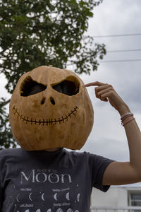 Cropped hand of woman holding pumpkin