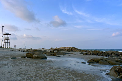Rocks on beach against sky