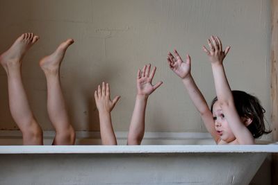 Playful brothers in bathtub at home