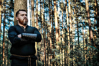 Man standing against trees