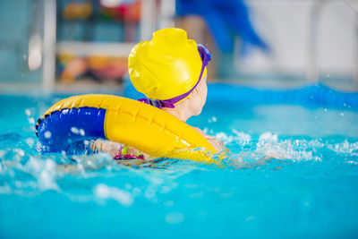 Close-up of yellow toy swimming in pool