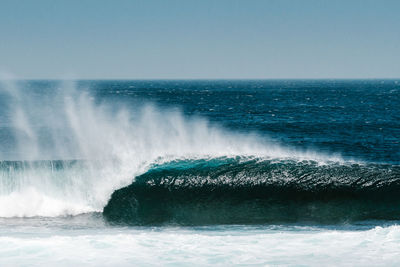 Scenic view of sea waves against clear sky