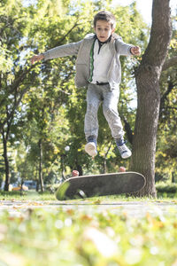 Boy skateboarding in park