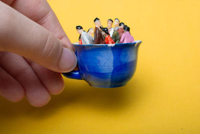 Close-up of person holding ice cream in bowl