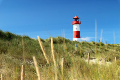 Low angle view of lighthouse against clear blue sky