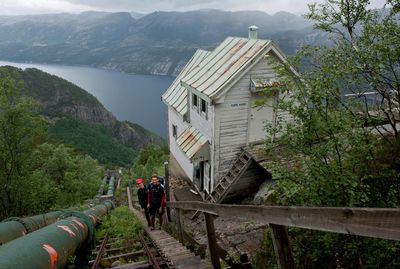 High angle view of male hikers standing on steps against valley