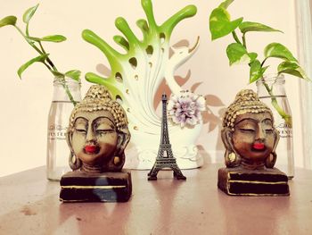 Close-up of buddha statue on table