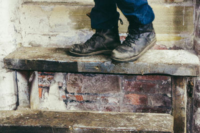 Low section of man on retaining wall