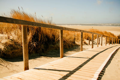 Pier over sea against clear sky