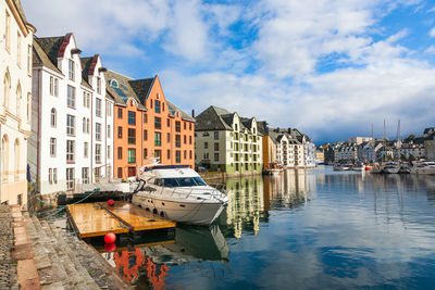 Cityscape at the canal with a boat in alesund, norway