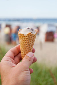 Cropped image of person holding ice cream cone