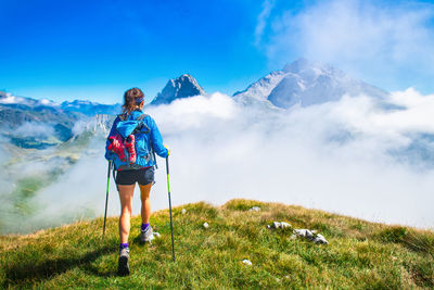 Man standing on mountain against sky