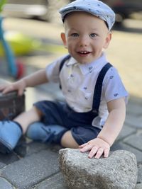 Portrait of a boy one year old wearing a retro country style helmet beret , excitement and dynamism 