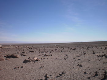 Scenic view of beach against blue sky