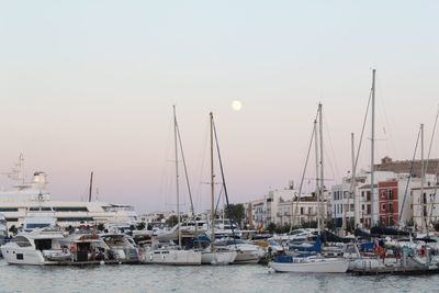 Boats in harbor at sunset